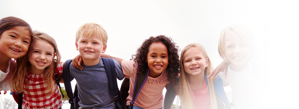 Children in a group, all smiling.